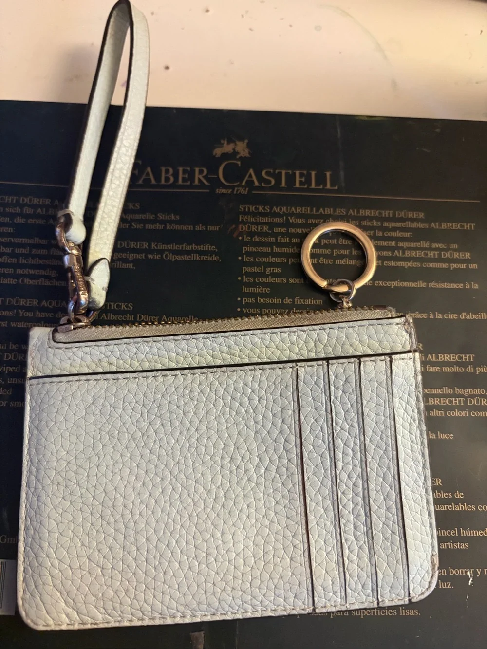 kate spade light blue pebbled leather wristlet with gold logo